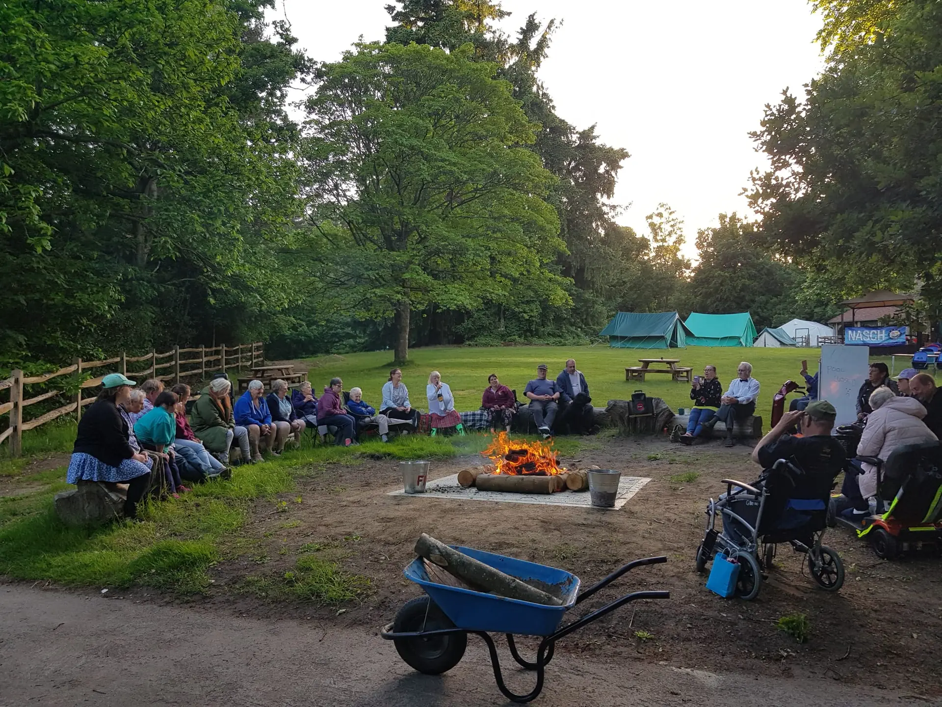 Campers round the camp fire.